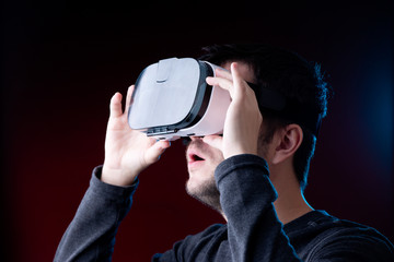 Photo of surprised young guy with glasses of virtual reality