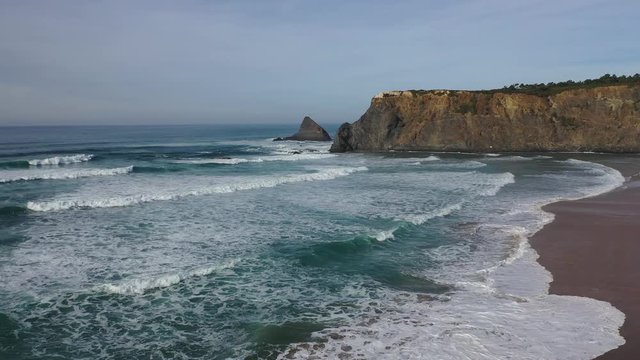 West Portugal aerial flight over Atlantic coastline ocean waves reachin Odeceixe beach