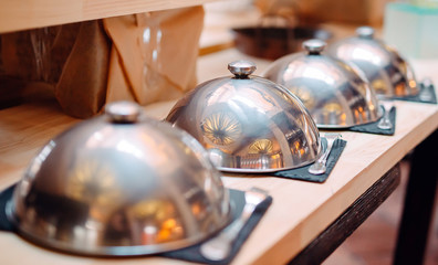 buffet in a restaurant or hotel. Metal dishes with caps.