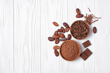 Chocolate with cocoa beans and bowl of chocolate chips and cacao powder for confectionery