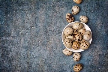 Top view on small quail eggs in white bowl