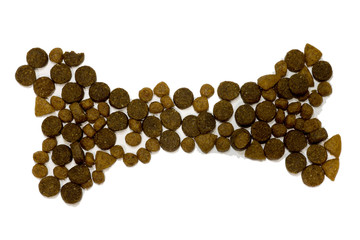 Stone laid out of dry dog food on a white background. Dry dog bone food