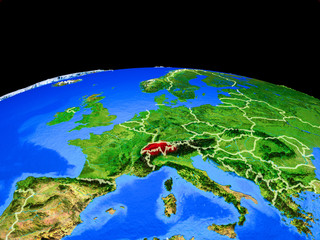 Switzerland on model of planet Earth with country borders and very detailed planet surface.