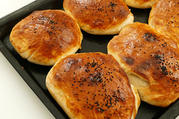 buns on the nigella seeds,homemade wonderful sesame buns, new baked buns in baking tray,