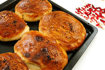 homemade wonderful sesame buns, new baked buns in baking tray,
