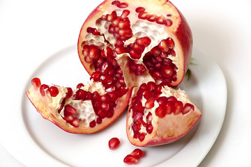 pomegranate grains in plate, very red pomegranate grains, looking great on white background