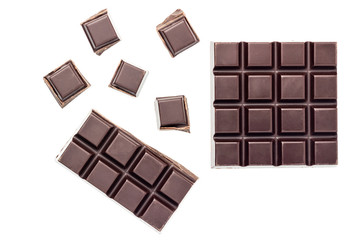 Chopped chocolate cubes, bitter, dark chocolate bar isolated on white background, top view