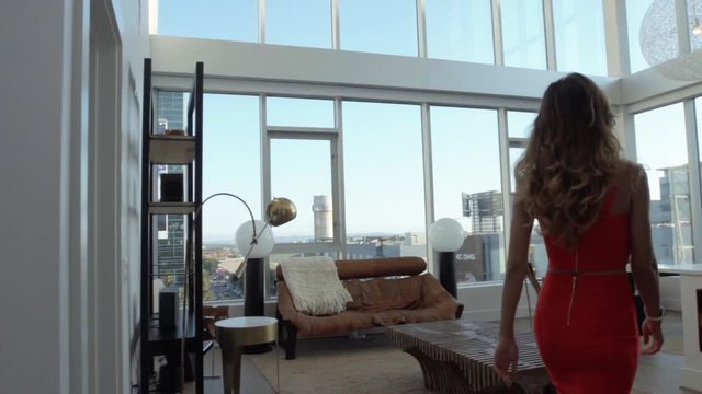 Pretty woman entering an impressive penthouse in Hollywood 