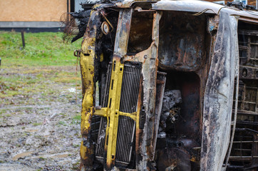 Fototapeta na wymiar Burnt car minibus yellow on the grass