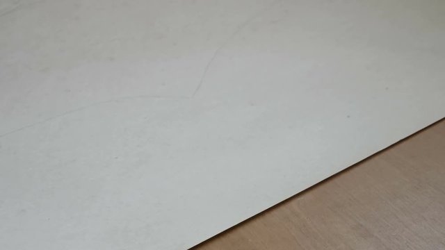 woman cuts the pattern for sewing dresses. designer working at her showroom making patterns for sewing on textile materials designing clothing.