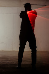 Portrait of a assassin man with laser weapon
