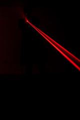 an holding gun with red laser