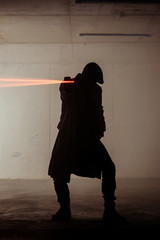 Portrait of a assassin man with laser gun