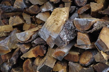 Split oak woodpile to feed the woodburning stove