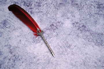  Red quill pen  . 