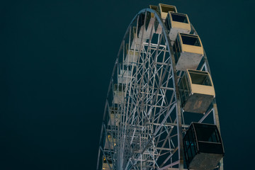 Ferris wheel in dark evening Kyiv on background with deep winter sky