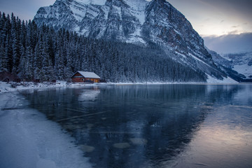 Lake Louise Banff Canada during the winter season. Blue hour after sunset on a cold winter night. Still glacial lakes in the Canadian Rockies. First snow fall at Lake Louise.
