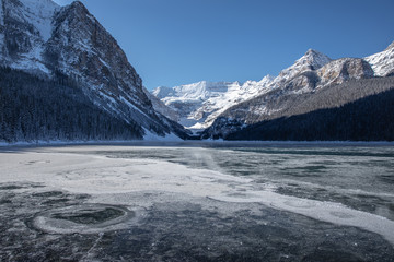 Lake Louise Banff Canada during the winter season. Frozen glacial lakes in the Canadian Rockies. Cold winter morning at Lake Louise just when the lake froze.