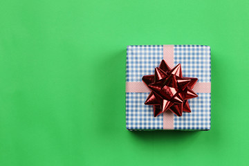 Blue Gift box on green paper background and have copy space.