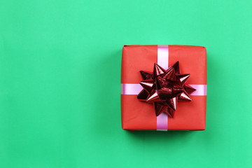 Red Gift box on green paper background and have copy space.