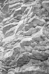 View of natural limestone relief. Colored, irregular stone surface; Natural stone layer for background or texture