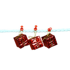 Red gift box hanging on rope isolated on white background.
