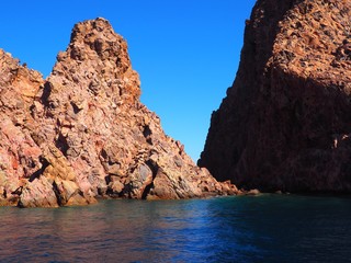 Rock formations with blue sky and water