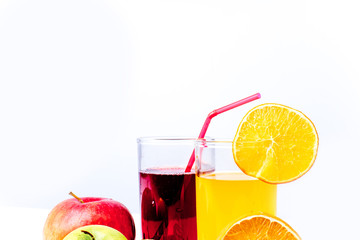 different fruit and juice or smoothie in a glass