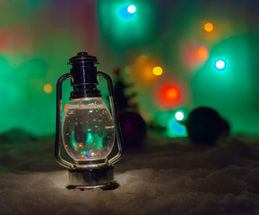 Christmas photo with a lamp and blurry garland and Christmas tree toys on the background.new year card.New Year's photo with a lamp