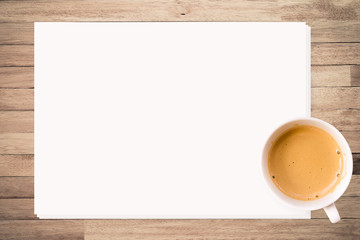 Workplace Coffee on white paper on wooden background 