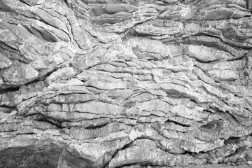 View of natural limestone relief. Colored, irregular stone surface; Natural stone layer for background or texture