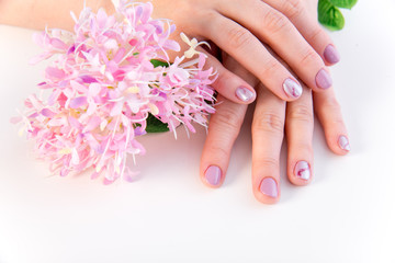 female hand skin care - hands holding flowers