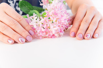 Fototapeta premium female hand skin care - hands holding flowers