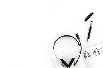 Desk of musician for songwriter work with headphones and notes white background top view mockup