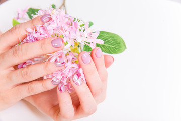 Obraz na płótnie Canvas female hand skin care - hands holding flowers