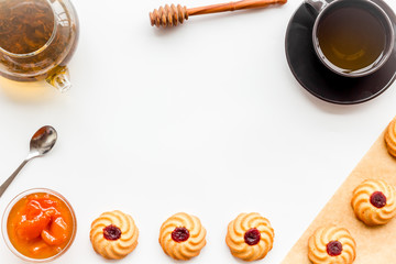 Tea with homemade cookies. Fresh cookies, cup of tea, teapot on white background top view copy space frame