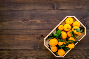 Winter fruits for New Year and Christmas. Tangerines on wooden background top view mock-up