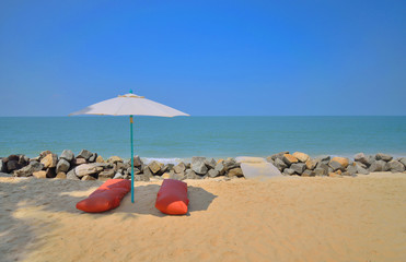 Fototapeta na wymiar White Umbrella providing shade in the beautiful marari sea beach.