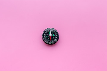 Direction concept with compass on pink background top view space for text