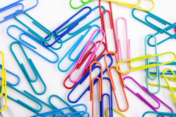 A pile of colorful paperclips on white background, Abstract background. Stationery concepts.