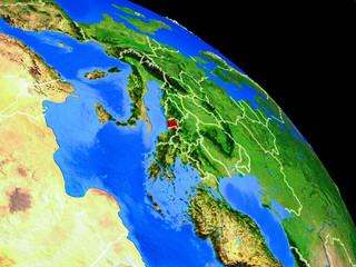 Montenegro on planet Earth from space with country borders. Very fine detail of planet surface.