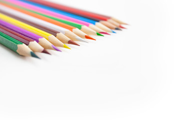 Closeup, Selective focus on the tips of the colorful crayon pencils on white background with copy space.