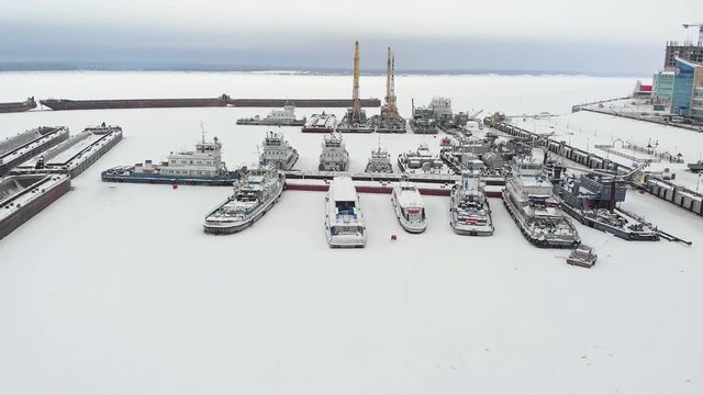 river port, standing of cargo ships, vessel with a crane, winter, aerial survey, top view