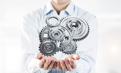 Engine mechanism in male ahnds as symbol for cooperation or team