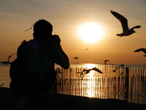The man take the sunset photo at Bangpu Recreation Center ,Samut Prakan THAILAND.