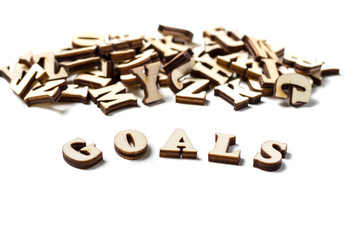 The word goal written in wooden letters, the concept of setting goals