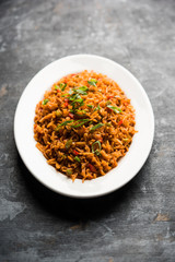 Schezwan Fried Rice Masala is a popular indo-chinese food served in a plate or bowl with chopsticks. selective focus