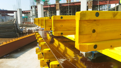 Wood girder stacked at a construction site. Girders provide platforms for stage structure support