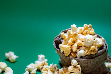 Popcorn in a box spread on a colored background