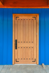 Wooden door with black metal riveted pins